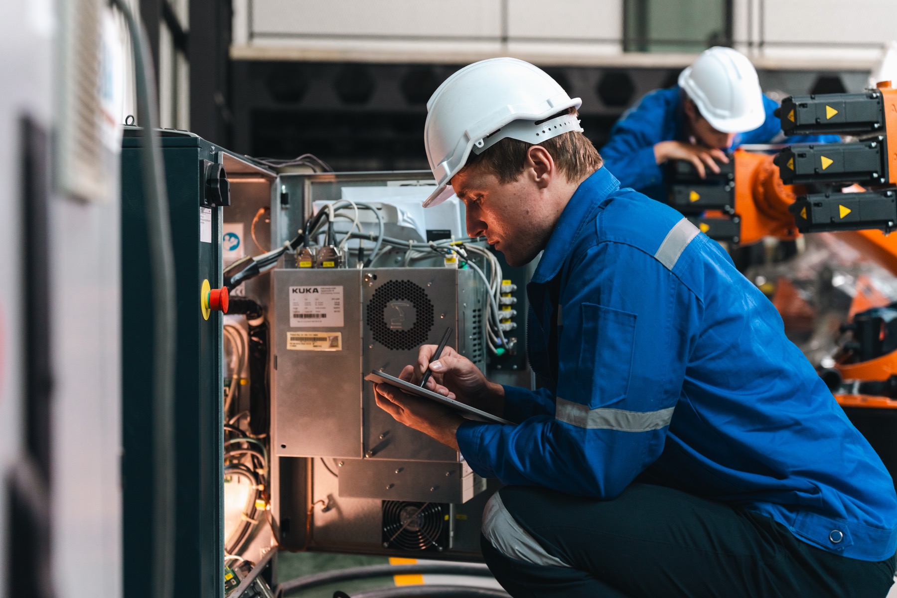 Industrial technician documenting equipment during technical review